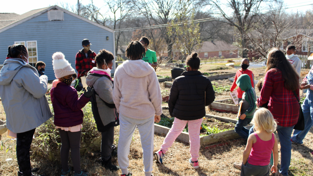 Families play and explore nature during a lesson with Unearthing Joy