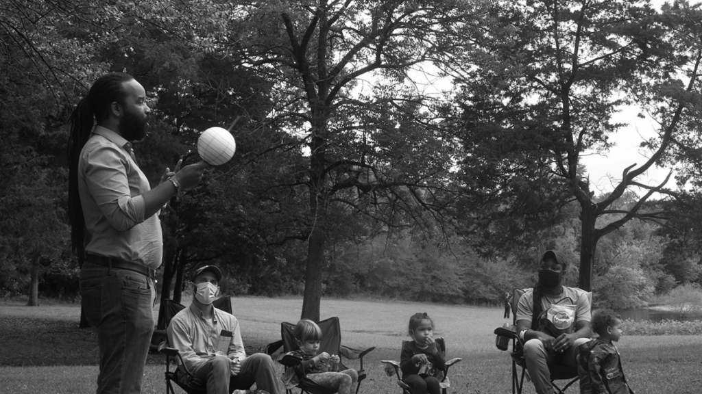 Families play and explore nature during a lesson with Unearthing Joy