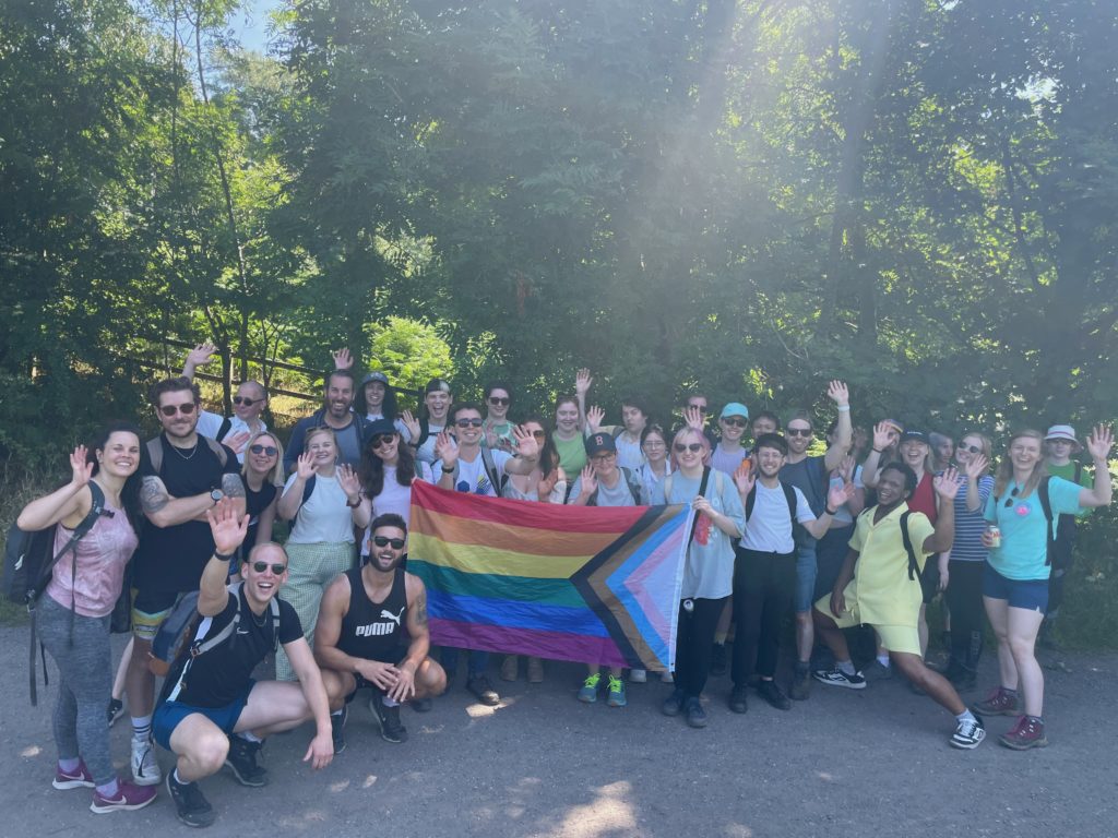 A group of hikers pose for a photo during a Queer Out Here event