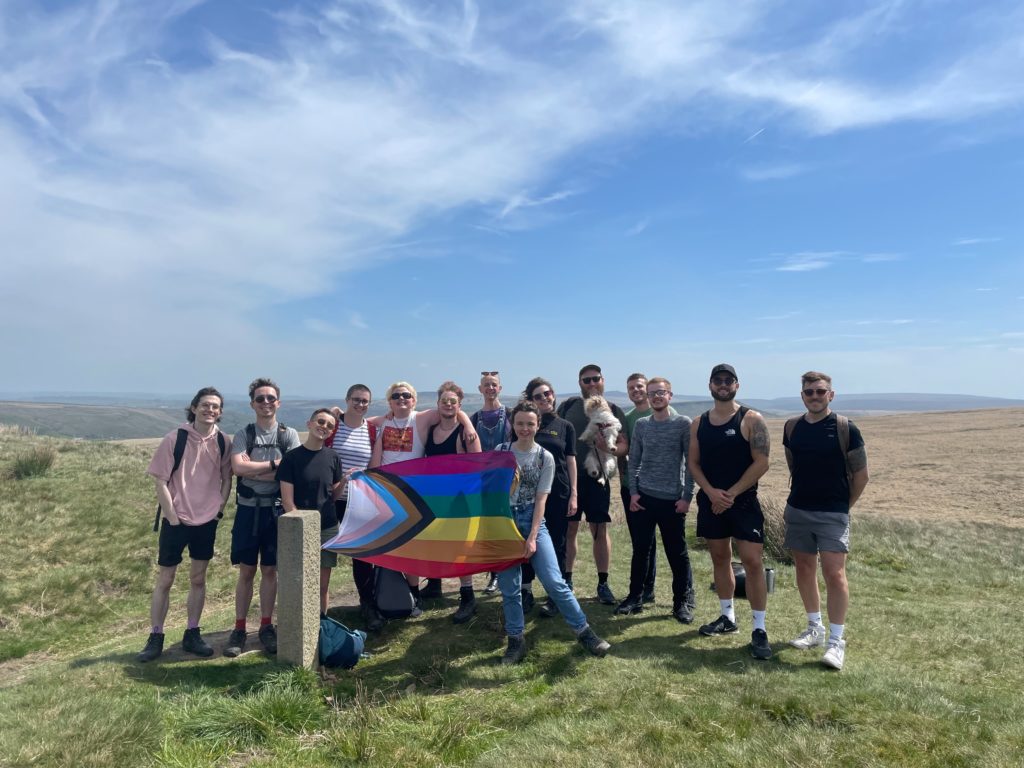 A group of hikers pose for a photo during a Queer Out Here event